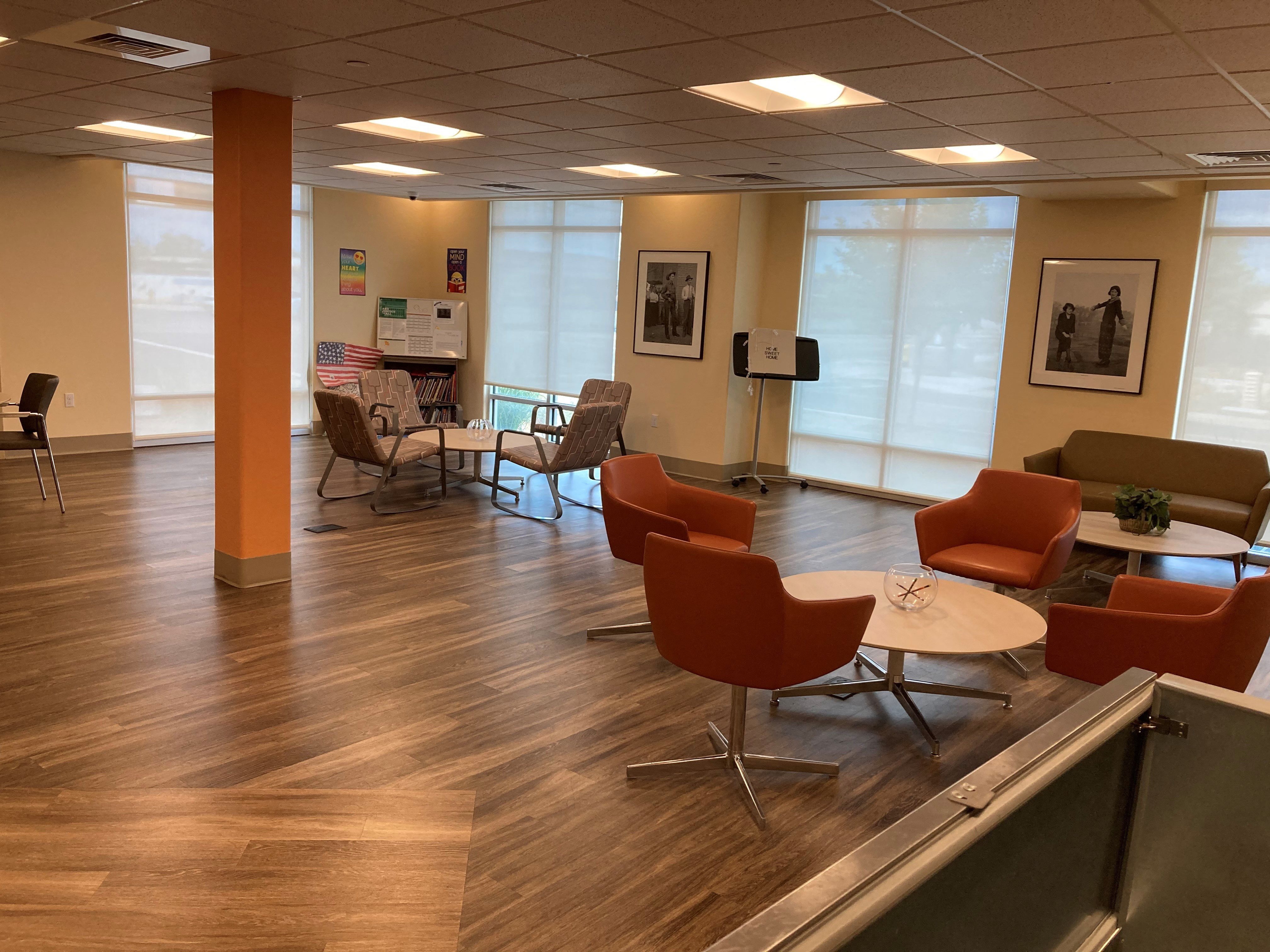 an empty waiting room with chairs and tables
